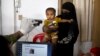FILE - A Bangladeshi officer takes the photograph of a Rohingya boy while his mother holds him during the process of registration at Kutupalong refugee camp near Cox's Bazar, Bangladesh, Jan. 16, 2018.