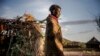 FILE - A woman of the Turkana community walks on her way to her house early in the morning in an arid dry area in Morungole, Turkana county, Kenya, Oct. 4, 2019. 