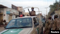 Security forces patrol at a suicide bomb blast site in Bannu