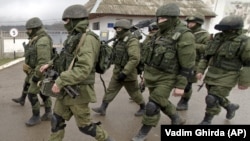 UKRAINE – Russian soldiers march outside a Ukrainian military base in Perevalne, Crimea, March 20, 2014.