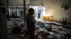 An Ethiopian owner of a looted grocery store stands in his ransacked shop, in Soweto, Johannesburg, South Africa, Aug. 29, 2018.