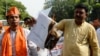 FILE - Demonstrators burn a copy of the report of the Office of the United Nations High Commissioner for Human Rights during a protest outside the United Nations office in New Delhi, June 25, 2018. The first-ever U.N. report on Kashmir accuses India and Pakistan governments of committing atrocities in the divided region.