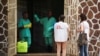 FILE - Medecins Sans Frontieres (MSF) workers talk to a worker at an isolation facility, prepared to receive suspected Ebola cases, at the Mbandaka General Hospital, in Mbandaka, Democratic Republic of Congo, May 20, 2018.