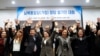 A group of North Korean defectors pose for photographs during the launching ceremony of their political party South-North Unification Party, ahead of the country's general election in April, in Seoul, South Korea, Feb. 18, 2020.
