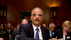 Attorney General Eric Holder prepares to testify before a Senate Appropriations subcommittee on Capitol Hill, Washington, June 6, 2013.