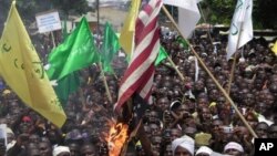 Muslims burn an American flag following a protest over an anti-Islam video that denigrates the Prophet Muhammad, in Kaduna, Nigeria, September 24, 2012.