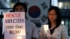 FILE - Members of the Korean Abductees to North Korea, the supporting group for those abducted by North Korea at the 1950-53 Korean War, participate at an anti-Koreas Summit candle rally in front of the government house in Seoul, South Korea, Oct. 2, 2007