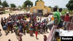 FILE - People queue for food aid distribution delivered by the United Nations Office for the Coordination of Humanitarian Affairs and world food program in the village of Makunzi Wali, Central African Republic, April 27, 2017.