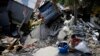 A boy sits with items salvaged from the ruins of a house in the Balaroa neighborhood in Palu, Central Sulawesi, Indonesia, Oct. 2, 2018. 