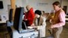 An election official helps a voter to cast her ballot at a polling station in Ridgeland, Mississippi, U.S., Nov. 27, 2018. 