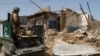 Pakistani soldiers look at a house which was destroyed during a military operation against Taliban militants, in the of town of Miranshah, North Waziristan July 9, 2014. The Pakistani military has seized control of 80 percent of Miranshah, the capital of 