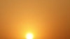 The sun rises behind electricity pylons in Beijing, China.
