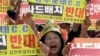 FILE - A resident in a rural South Korean town shouts slogans to protest a plan to deploy an advanced U.S. missile defense system called Terminal High-Altitude Area Defense, or THAAD, in their neighborhood, in Seoul, South Korea.