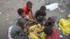Boys eat bread they collected from a garbage dump on the outskirts of the Red Sea port city of Hodeida, Yemen January 7, 2018. 