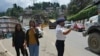 A traffic policewoman wearing a face mask controls the flow of traffic in Kohima, capital of the northeastern Indian state of Nagaland, May 29, 2020. 