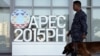A military personnel walks past an APEC logo with his sniffer dog at the media center of the Asia-Pacific Economic Cooperation (APEC) summit in the capital city of Manila, Philippines November 17, 2015. 
