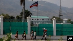 La gente pasa frente al Palacio Nacional en Puerto Príncipe, Haití, el lunes 25 de marzo de 2024. (Foto AP/Odelyn Joseph)