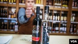 File - At a Kvint store, a saleswoman shows a vodka bottle. Scientists have used the spirit to send a text message (Vera Undritz for VOA)