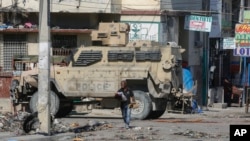 Un auto de policía blindado patrulla la zona del Hospital General, en Puerto Príncipe, Haití, el martes 2 de abril de 2024.