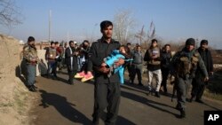 An Afghan Security police carries his injured daughter after an attack near the Bagram Air Base In Parwan province of Kabul, Afghanistan, Wednesday, Dec. 11, 2019.