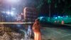 A Thai policeman guards an area under rainfall near the Tham Luang cave at the Khun Nam Nang Non Forest Park in Mae Sai district of Chiang Rai province, July 7, 2018, as rescue operation continues for the 12 boys and their football team coach.