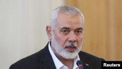 FILE PHOTO: Palestinian group Hamas' top leader, Ismail Haniyeh and Iran's Foreign Minister Hossein Amir Abdollahian attend a press conference in Tehran