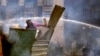 An anti-government protester throws a Molotov cocktail during clashes with riot police in Kiev's Independence Square, the epicenter of the country's current unrest, Kiev, Ukraine, Wednesday, Feb. 19, 2014.