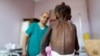 A nurse looks as he weighs a malnourished girl at a malnutrition treatment center in Sanaa, Yemen, Oct. 7, 2018. 