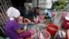 FILE - Migrant workers clean fish in Songkhla, Thailand, Dec. 23, 2015.