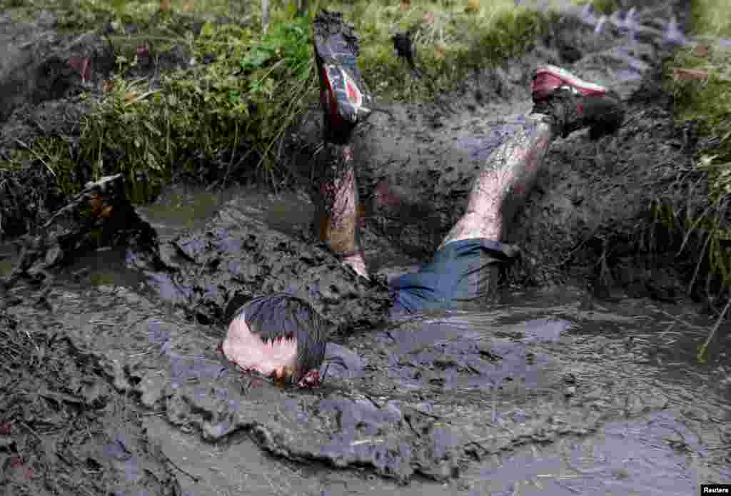 A man takes part in an extreme run competition in Zhodino, east of Minsk, Belarus, Sept. 26, 2015.