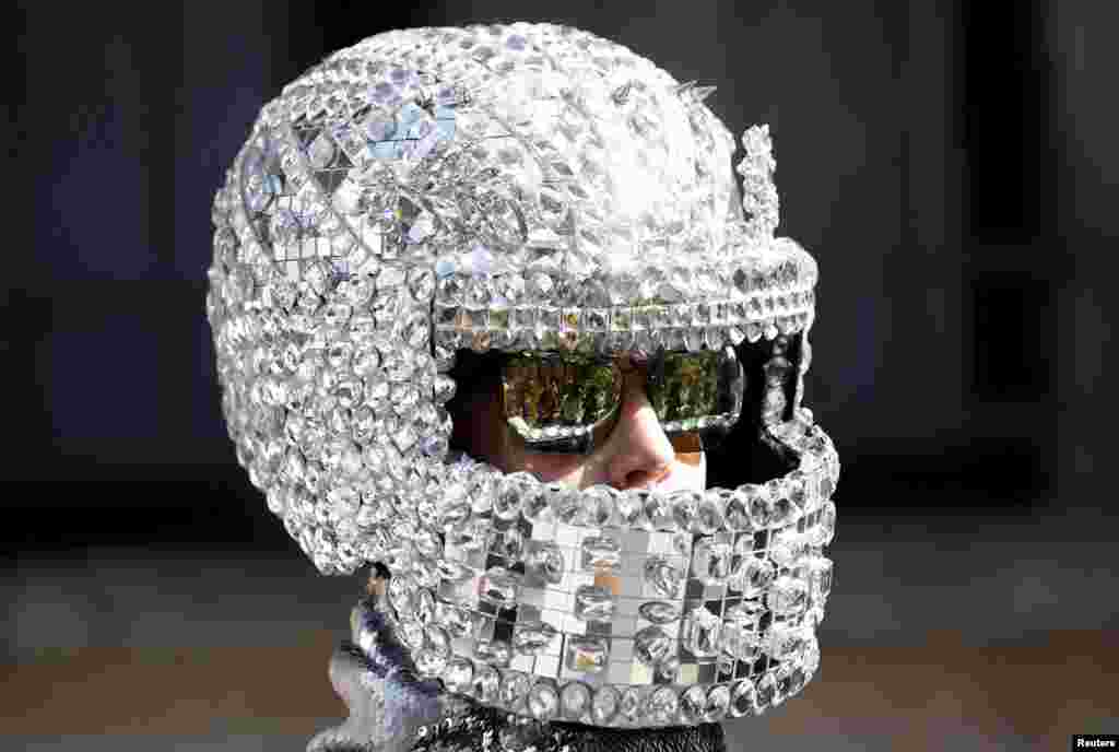 A person wears a helmet during the Spring/Summer 2016 collections at the Milan Fashion Week in Italy, Sept. 26, 2015. 