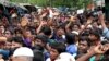 FILE - Rohingya refugees shout slogans as they take part in a protest at the Kutupalong refugee camp to mark the one-year anniversary of their exodus, in Cox's Bazar, Bangladesh, Aug. 25, 2018.