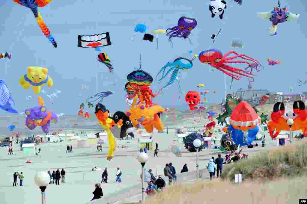 People fly kites during the international kite festival in Berck-sur-Mer, northern France, April 13, 2013. 