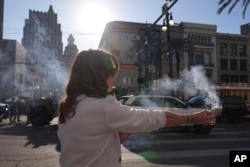 Stephanie Drake quema salvia en Canal y Bourbon Street, el 2 de enero de 2025 en Nueva Orleans.