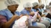 FILE - Mothers breastfeed their newborn babies in the natal intermediate care unit at the Santa Ana public maternity hospital in Caracas, Oct. 22, 2011. 