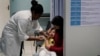FILE - A health worker vaccinates a toddler against measles in Rio de Janeiro, Brazil, Aug. 6, 2018