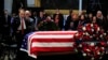 Former Sen. Bob Dole salutes the flag-draped casket containing the remains of former President George H.W. Bush as he lies in state at the U.S. Capitol in Washington, Dec. 4, 2018.