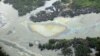 Oil surfacing near an illegal oil refinery in Ogoniland in Nigeria's Delta region, March 24, 2011.