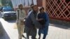 Afghan men carry a wounded person to the hospital after a suicide attack in Jalalabad, Afghanistan, June 13, 2019. 