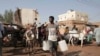FILE - People gather to collect water in Khartoum, Sudan, May 28, 2023.