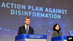 European Commissioner for Digital Single Market Andrus Ansip, left, and European Commissioner for Justice Vera Jourova participate in a media conference at EU headquarters in Brussels, Dec. 5, 2018. 