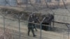 South Korean army soldiers patrol the barbed-wire fence in Paju, near the border with North Korea, South Korea, Wednesday, Jan. 6, 2016.