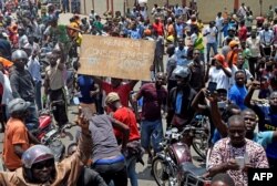 Protesters march with placards as they call for reforms during an anti-government rally in Lome, Togo, Sept. 6, 2017.