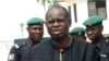 Bayelsa State Governor Diepreye Alamieyeseigha stands outside his house guarded by policemen in Yenagoa, Nigeria, in this photo dated November 27, 2005.