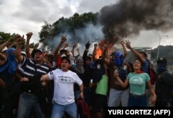 VENEZUELA -- Venezuelan opposition demonstrators, chant slogans during a protest against the government of President Nicolas Maduro, on the anniversary of 1958 uprising that overthrew military dictatorship in Caracas on January 23, 2019.