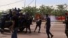 FILE - Riot policemen fire tear-gas canisters to disperse supporters of Congolese opposition presidential candidate Martin Fayulu as they welcome him at N'djili International Airport in Kinshasa, Democratic Republic of Congo, Nov. 21, 2018.