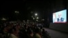 People watch as Prime Minister Narendra Modi delivers an address to the nation, on a TV screen in Ahmedabad, India, Aug. 8, 2019. 