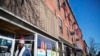 U.S. flags hang outside a downtown building whose storefronts are made up of businesses started by African immigrants who have settled in Lewiston, Maine, March 17, 2017. Maine's immigrants from Sub-Saharan Africa made $136.6 million in income in 2014, and paid $40 million in taxes, according to a report from the New American Economy. 