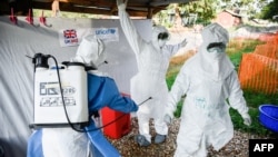 Medical staff of the Ebola Treatment Unit (ETU) get ready to work in their Personal Protective Equipment (PPE) during their weekly rehearsal at the Bwera General Hospital in Bwera bordering with DRC, western Uganda, on Dec. 12, 2018.