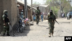 Nigerian soldiers are seen patrolling a town in the north-eastern state of Borno in this April 30, 2013, file photo.